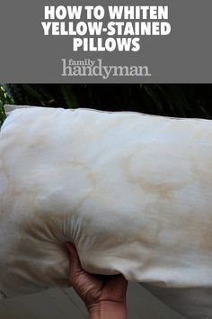 a person holding a pillow with the words how to whiten yellow - stained pillows