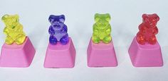 four gummy bears sitting on top of each other in the shape of three different colors