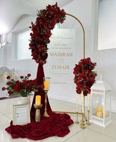 red roses are on display in front of a mirror and other decorations for a wedding