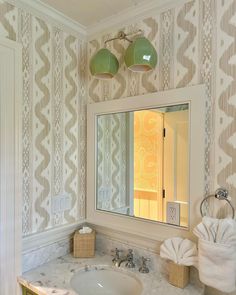 a bathroom with a sink, mirror and towel rack on the counter top in front of it