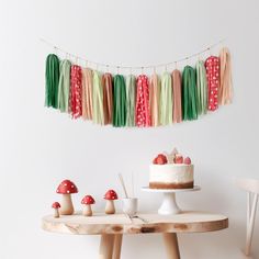 a table with cake, mushrooms and streamers on it