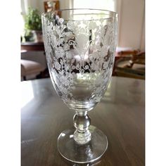 an empty glass sitting on top of a wooden table