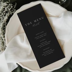 the menu card is sitting on top of a white plate