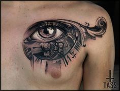 a man's chest with an eye tattoo on it