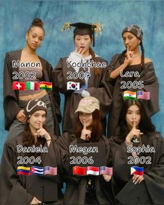 a group of women in graduation gowns posing for a photo with flags on them