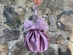 🔘 This Elegant Satin Ruffle bag is ideal for the wedding day, night out, party, special occasion, brides, bridesmaids, mothers of the bride, or any formal fun. 🔘 This bag has an elastic opening and a stiff bottom.   🔘 Please contact for a custom order. 🔘 Material: Satin fabric, lace. The lining fabric is the same fabric as on the outside.  🔘 Measurements: - The bottom diameter is 12 cm/4.7 inches. - Height comes in 3 different measurements and the height was measured until the ruffles and e Feminine Evening Pouch Shoulder Bag, Feminine Shoulder Bag With Removable Pouch For Party, Purple Evening Bag For Wedding, Purple Wedding Evening Bag, Wedding Clutch Bag With Dust Bag Included, Elegant Purple Pouch Shoulder Bag, Feminine Handheld Evening Bag, Chic Satin Evening Bag For Wedding, Elegant Satin Wedding Bag