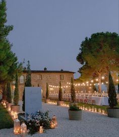 an outdoor wedding venue with candles and flowers