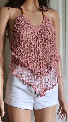 a mannequin wearing a pink crochet top with white shorts on it