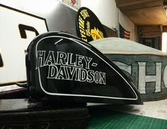 the harley davidson logo is on top of an old hockey helmet and other memorabilia in a garage