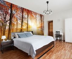 a bedroom with wood floors and a large painting on the wall