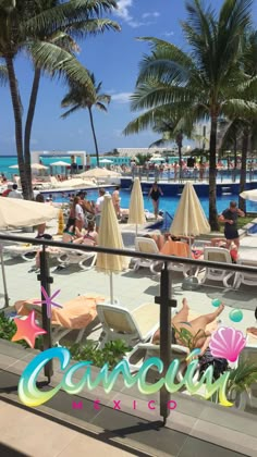 people are relaxing at the beach with umbrellas and lounge chairs in the foreground