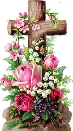 a cross with pink roses and white flowers on it next to a wooden stick that says jesus