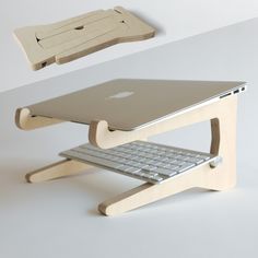 an apple computer sitting on top of a wooden stand with a keyboard attached to it