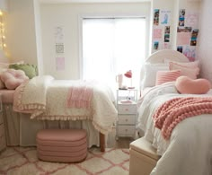 a bedroom with two twin beds and pink accessories