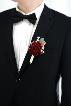 a man in a tuxedo with a boutonniere on his lapel