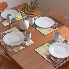 the table is set with white plates and placemats