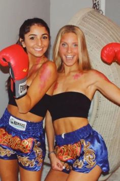 two women with painted faces and boxing gloves