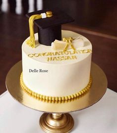 a cake with a graduation cap and tassel on top is sitting on a table