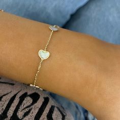 We know you'll adore the Mother of Pearl Heart Bracelet! This piece can be flawlessly paired with any other bracelet, or stand alone for a simple yet striking statement. Metal: 14k Yellow Gold Length: 7 inches Closure: Lobster clasp Looking for a different size? Please email us. Classic Heart-shaped Bracelets With Polished Finish, Luxury Heart Bracelet As A Gift, Classic White Gold Heart Bracelets, Classic Heart Shaped White Gold Bracelet, Classic White Heart-shaped Bracelet, Delicate 14k Gold Bracelets For Valentine's Day, Luxury Heart Cut Bracelet As Gift, Elegant White Bracelet With Heart Charm, Luxury Sterling Silver Bracelets For Valentine's Day