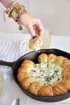 a person dipping some food into a skillet