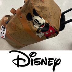 Embark On Your Travels In Style With This Officially Licensed Mickey Mouse Wheeled Duffle Bag, A Must-Have For Disney Enthusiasts. Crafted From Durable Printed Pu Material, This Bag Showcases The Timeless * Officially Licensed: This Wheeled Duffle Bag Proudly Features The Iconic Mickey Mouse And Is Officially Licensed By Disney. * Printed Pu: The Bag Is Constructed With Durable Printed Pu Material That Showcases Mickey's Timeless Charm. * Trolley Design: With A Convenient Trolley Design, This Wh Disney Style Brown Travel Bag, Disney Brown Travel Bags, Disney Red Travel Bag, Playful Mickey Mouse Bags For Disney Trips, Duffle Bag With Wheels, Cheap Mickey Mouse Travel Backpack, Insulated Backpack, Rolling Duffle Bag, Disney Mickey Mouse Rectangular Bag