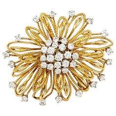 Absolutely gorgeous diamond and 18 karat yellow gold flower motif brooch. This beautifully textured piece is accented by incredible sparkling diamonds that shimmer throughout. The exquisite brooch features multiple layers of delicate, open gold petals in both smooth and textured finishes. There are 37 diamonds prong set in platinum, round brilliant in shape, H-I in color and VS2-SI1 in clarity. The diamonds form a domed cluster at the very center of the flower, as well as accenting the tips of t Luxury Yellow Gold Brooches With Single Cut Diamonds, Exquisite Diamond Brooches In Yellow Gold, Exquisite Yellow Gold Diamond Brooches, Yellow Gold Diamond Brooch Fine Jewelry, Yellow Gold Diamond Brooch In Fine Jewelry Style, Diamond Yellow Gold Brooches Fine Jewelry, Yellow Gold Diamond Brooches Fine Jewelry, Yellow Gold Diamond Brooches For Formal Occasions, Formal Yellow Gold Diamond Brooch