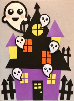 a paper cut out of a house with ghost faces on it