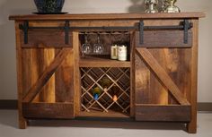 a wooden cabinet with wine glasses and bottles