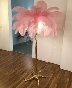 a pink feather lamp on a wooden floor