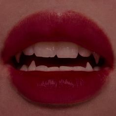 a woman's mouth with white teeth and red lipstick