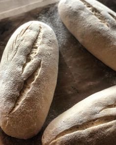 three loaves of bread sitting on top of a table