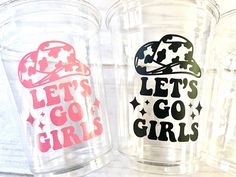 two plastic cups with the words let's go girls on them