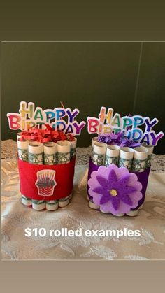 two birthday candles are sitting on a table with the words happy birthday written on them