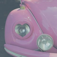 the front end of a pink car with a heart on it