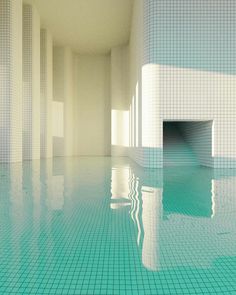 an empty swimming pool with tiled walls and floor