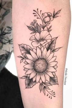 a black and white flower tattoo on the arm