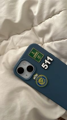 an iphone case with the number twenty five on it sitting on a white bed sheet