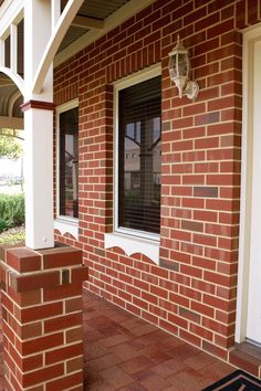 a red brick house with white trim and windows