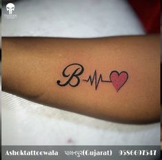 a person with a heart and heartbeat tattoo on their arm that says bm in cursive writing