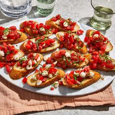 a white plate topped with slices of bread covered in toppings