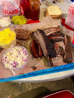 there are many different types of food on the trays, including ribs and coleslaw