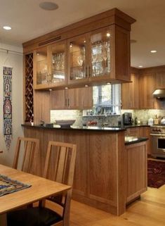 a kitchen with wooden cabinets and an island in front of the stove top oven is shown