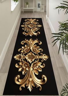 a long black and gold rug in the middle of a hallway with plants on either side