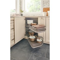 an open cabinet with pots and pans in it