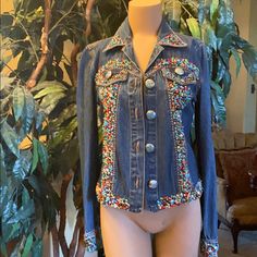 You Will Get Complements In This Stunning Turquoise Beaded Jean Jacket! Jacket Covered With Beads On Collar, Down Front, On Cuffs, On Waist And Design On Back!! No Stones Missing Or Loose!! The Cross On The Back Makes This Jacket Versatile Across Generations And Ability To Wear With Anything! Signature Gordon And James Designed #Turquoise #Country #Concert Blue Embellished Bohemian Outerwear, Fitted Multicolor Denim Jacket With Long Sleeves, Fitted Multicolor Long Sleeve Denim Jacket, Fitted Blue Embellished Outerwear, Blue Embellished Fitted Outerwear, Beaded Blue Denim Jacket For Spring, Fitted Beaded Outerwear For Fall, Fitted Long Sleeve Beaded Outerwear, Spring Beaded Blue Denim Jacket