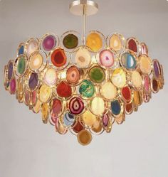 a chandelier made out of colorful glass discs