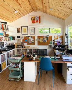 a home office with lots of books on the shelves