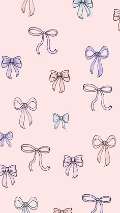 many different colored bows on a pink background