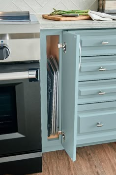 an open cabinet in the middle of a kitchen