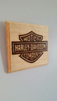 a wooden sign mounted to the side of a wall that says harley - davidson company